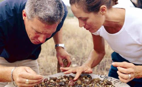 Fossickers sort through rock in search of colour after floods unearth a new deposit, sparking interest in the region. Fossickers sort through rock in search of colour after floods unearth a new deposit, sparking interest in the region.